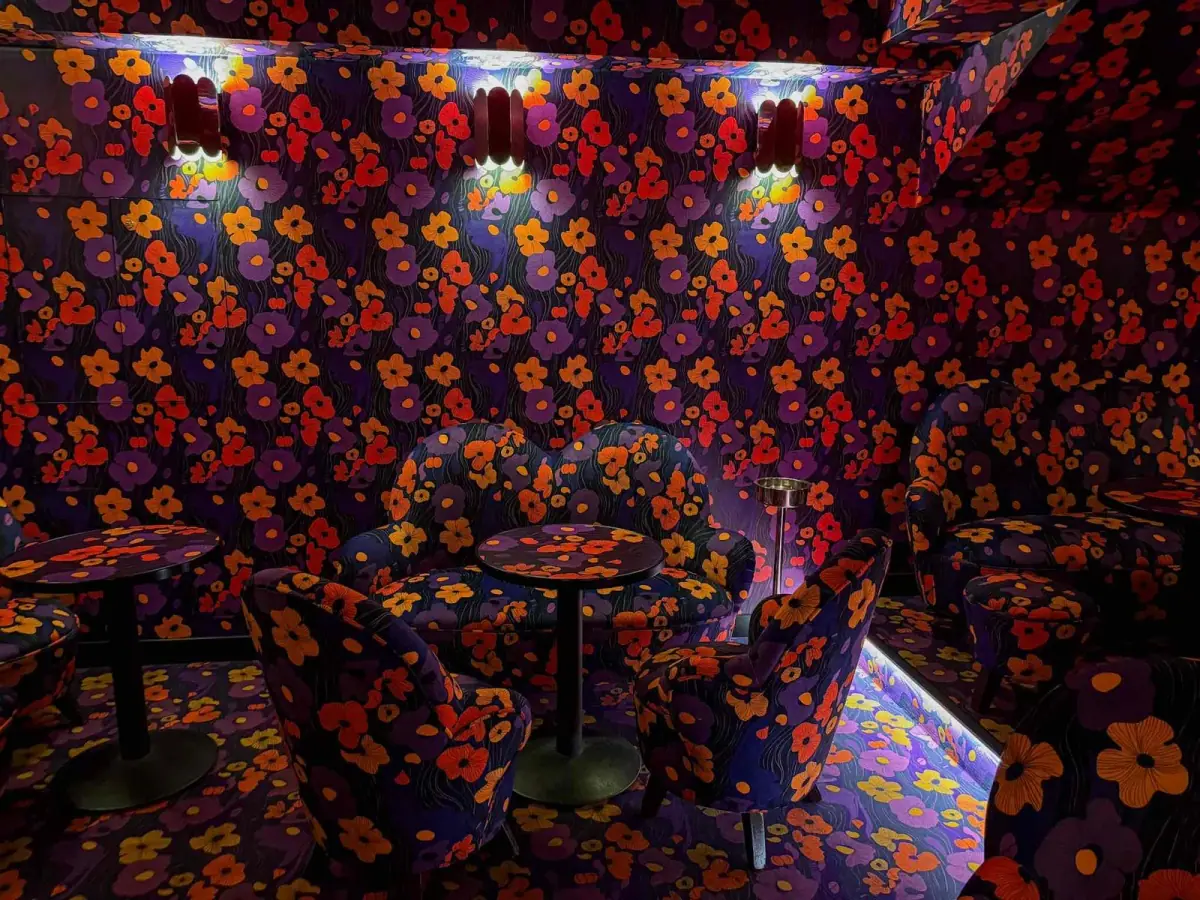 Cozy private room with floral wallpaper and upholstered seating